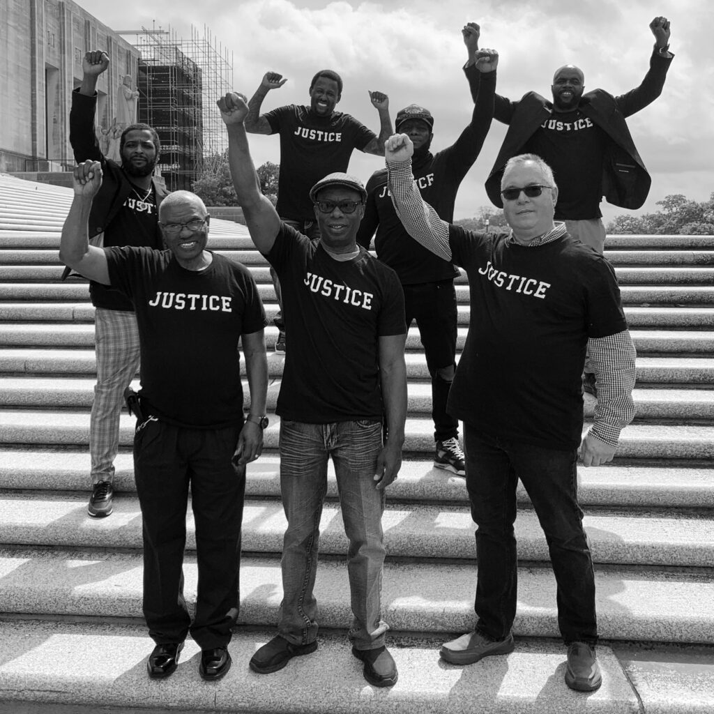 Innocence & Justice Louisiana Clients, hands raised