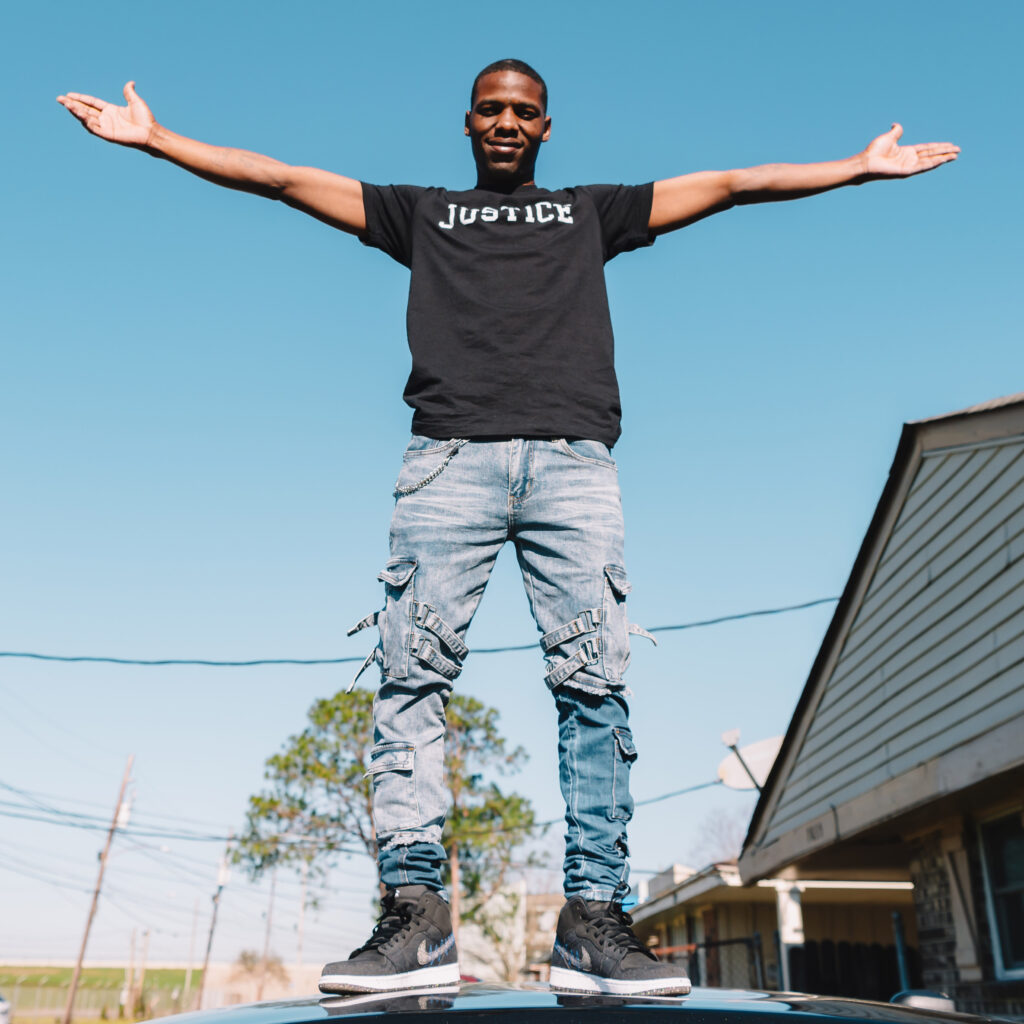 Kendall Gordon standing on a car